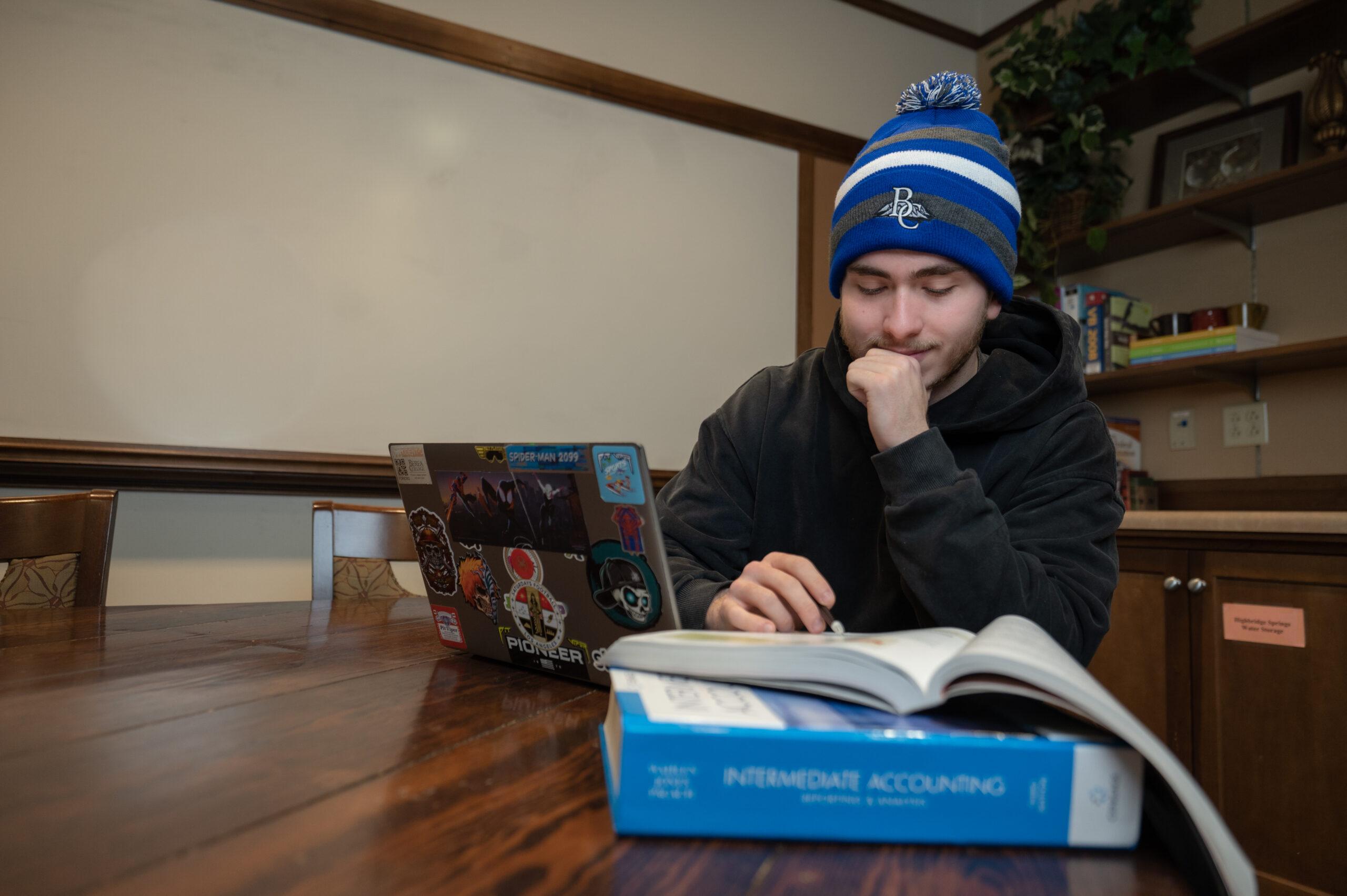 Student Aidan studying in the Business and Economics lounge.